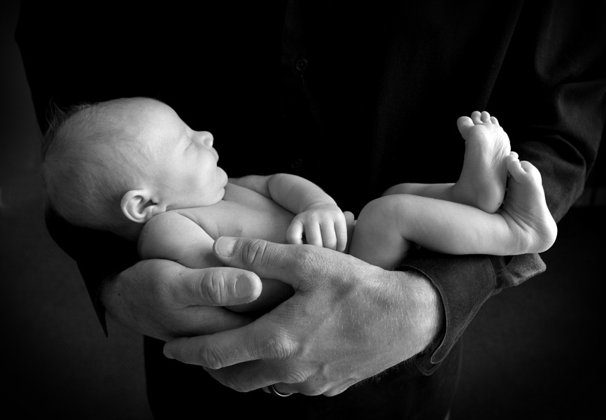 Infant in dad's hands